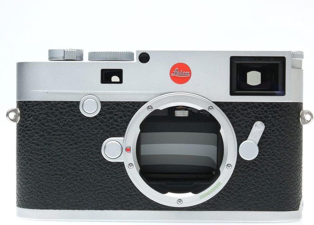 Close-up view of a Leica camera showcasing its sleek silver and black design, with a Leica logo and a mount for interchangeable lenses.