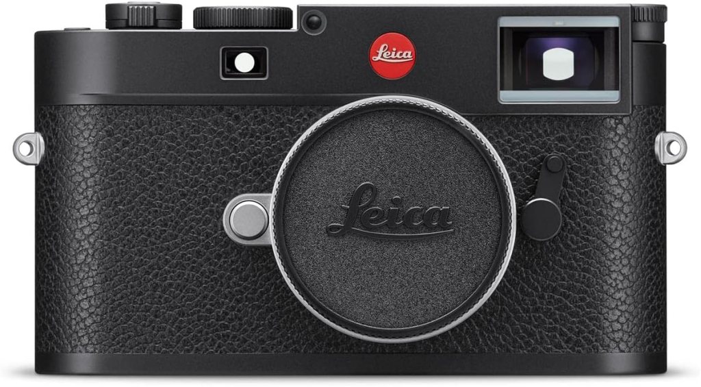 Front view of a Leica camera featuring a black textured body, a round lens cap, and the iconic red Leica logo.