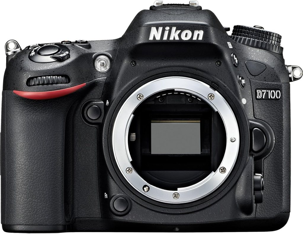 Front view of a Nikon D7100 DSLR camera, showcasing its body and lens mount.
