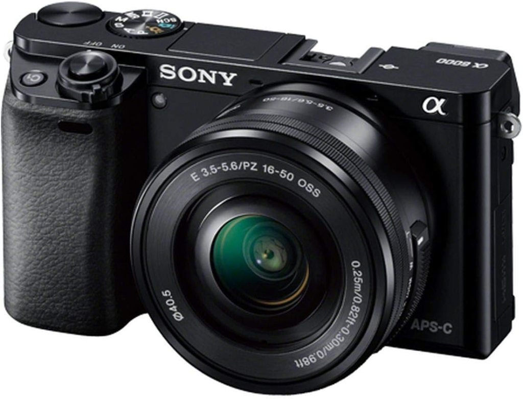 A black Sony mirrorless camera with a 16-50mm lens and APS-C sensor, featuring a textured grip and several dials on top.