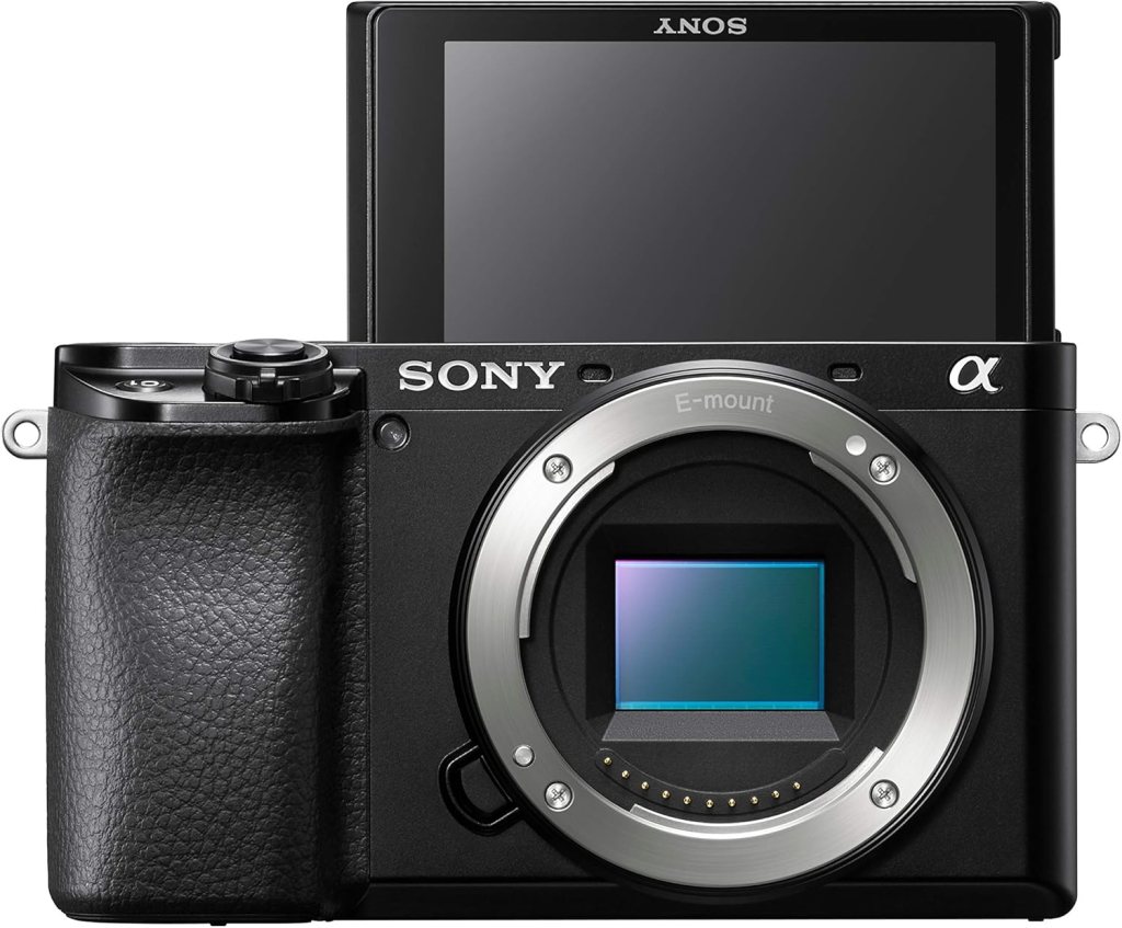 Sony a6100 camera showcasing its front view with an electronic viewfinder and flip-up screen.