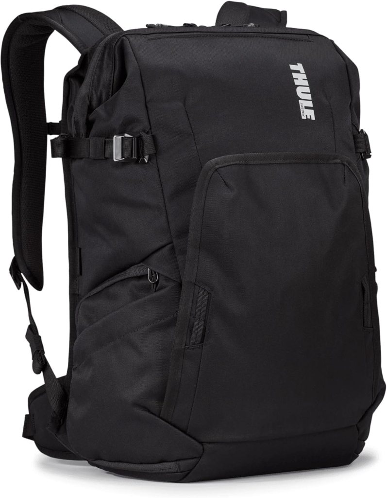 A sleek black Thule camera backpack with various pockets and adjustable straps, designed for durability and travel convenience.