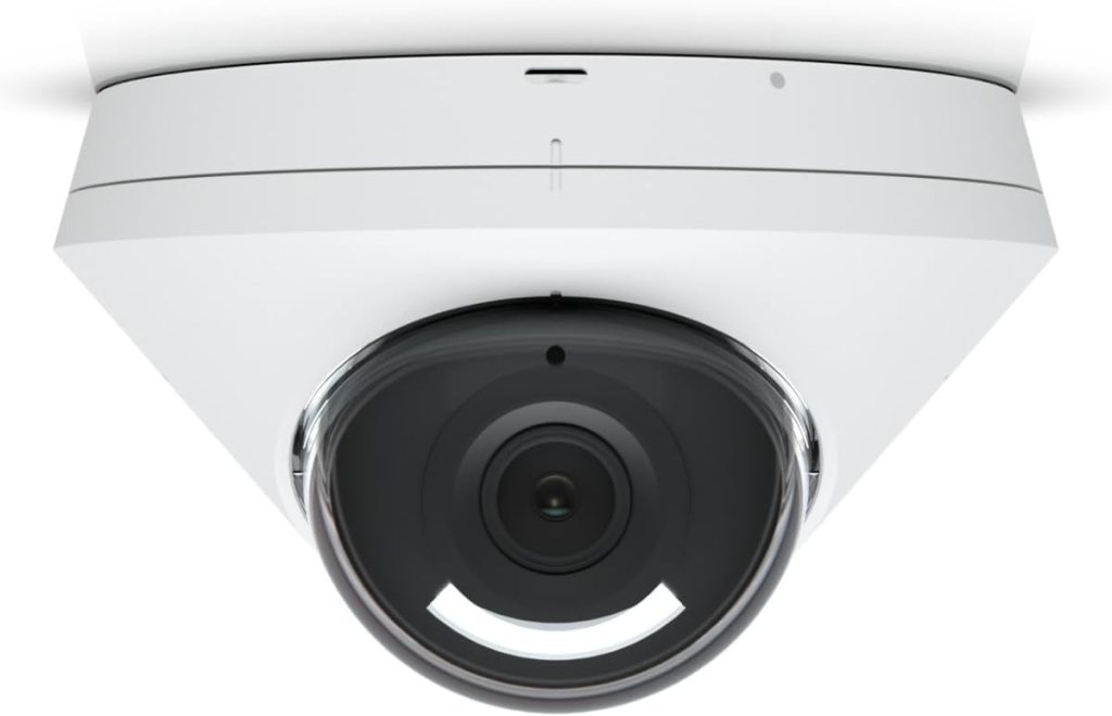 Close-up view of a white dome security camera mounted on a ceiling, showcasing its lens and sleek design.