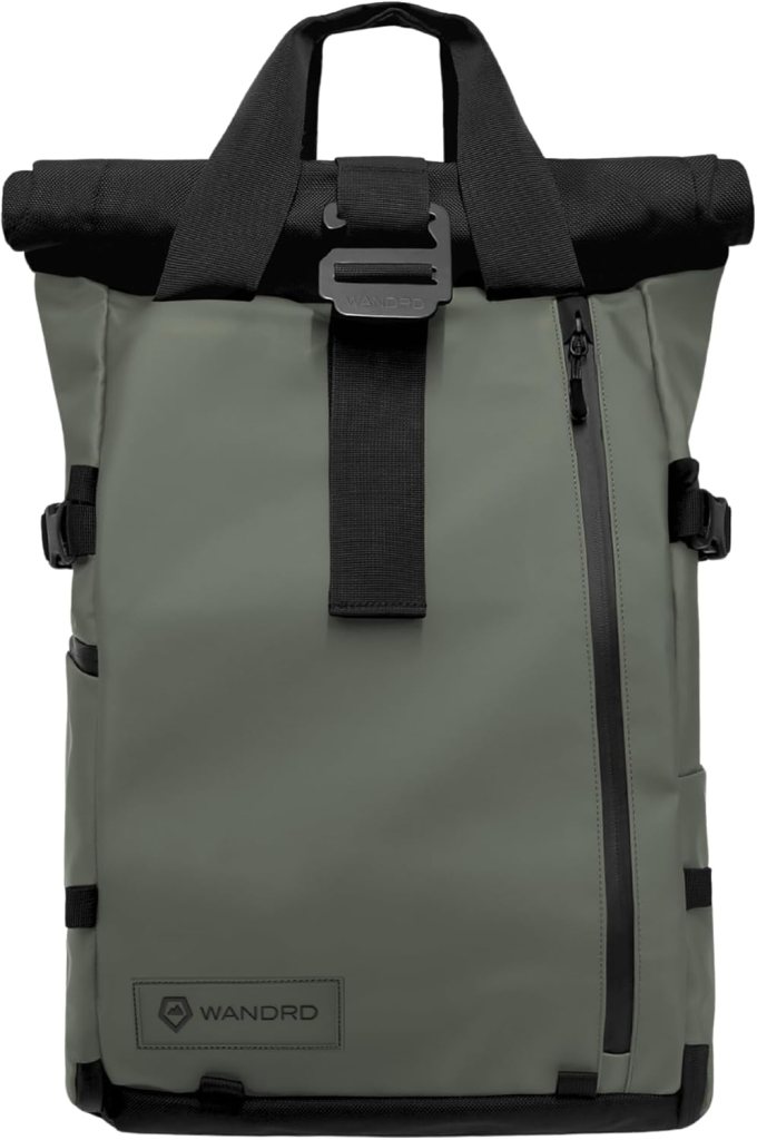 Front view of the WANDRD PRVKE roll-top travel backpack in a muted olive green color with black accents, showcasing its sleek design and durable materials.