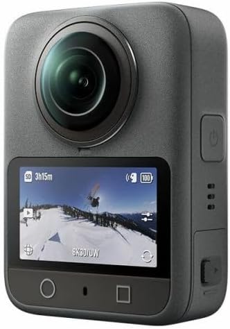 A compact action camera with a round lens and a rear display, showcasing a snowy landscape.
