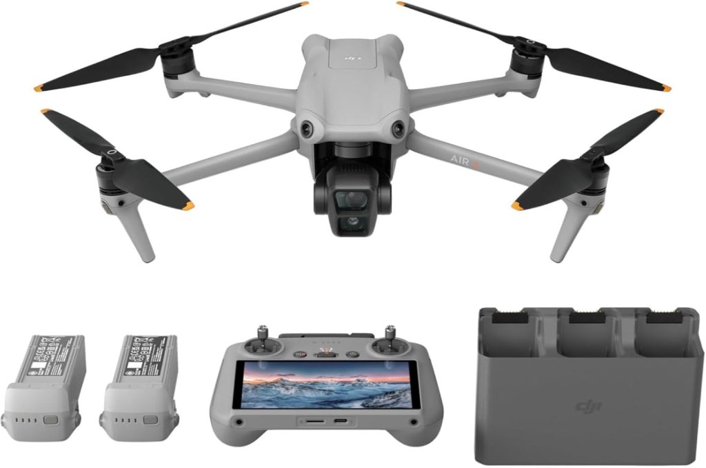A DJI Air 2 drone with its remote controller, two batteries, and a battery charging hub.