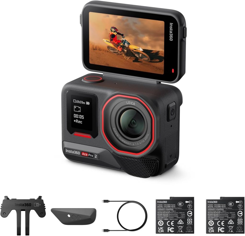 Insta360 Ace Pro 2 action camera with a flip screen displaying a motocross rider, accompanied by accessories including batteries and a USB cable.