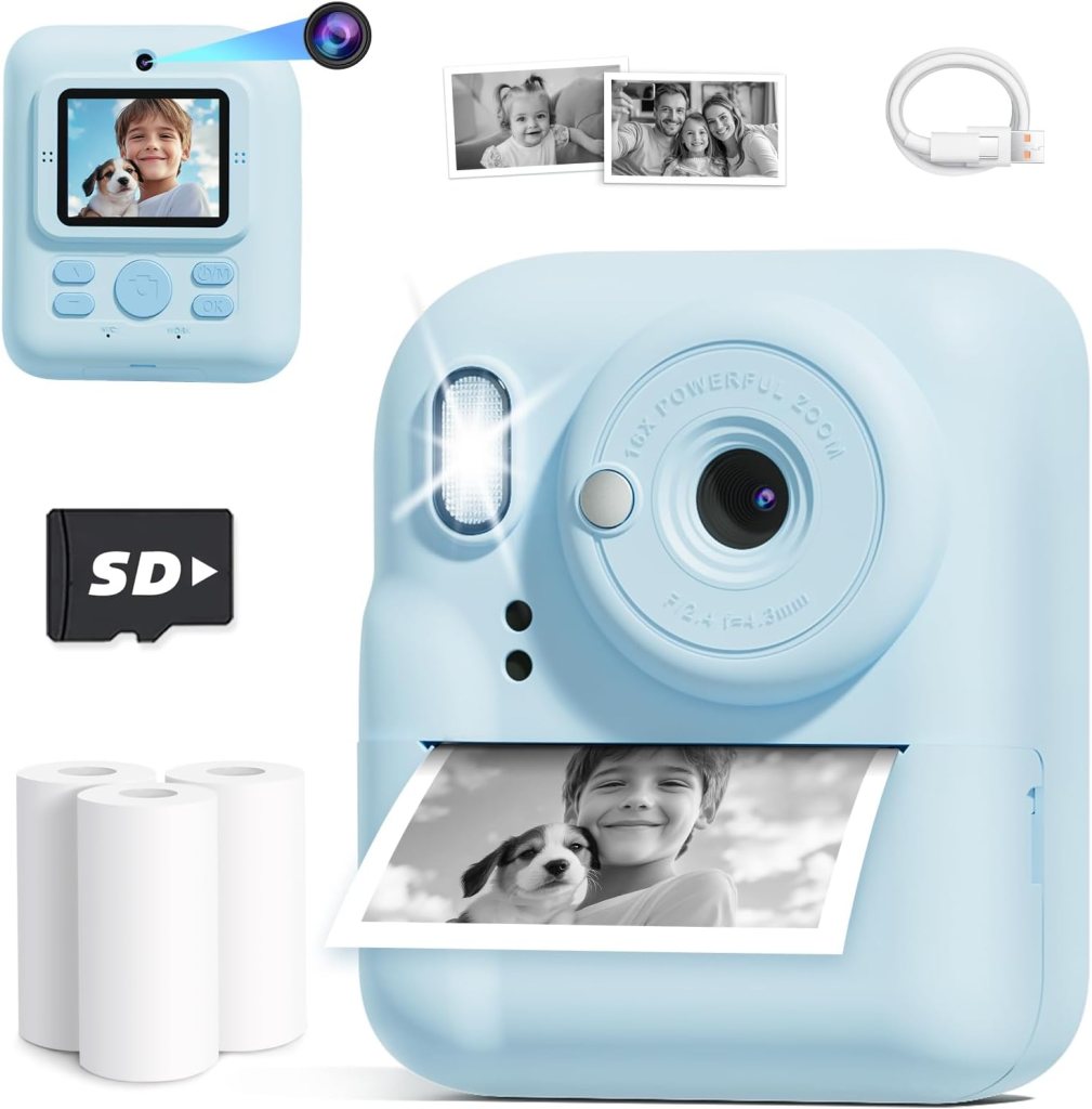 A light blue instant camera with a small screen, a lens, and a flash, showing a photo of a boy with a dog. Included are an SD card, a USB cable, and printer paper rolls.