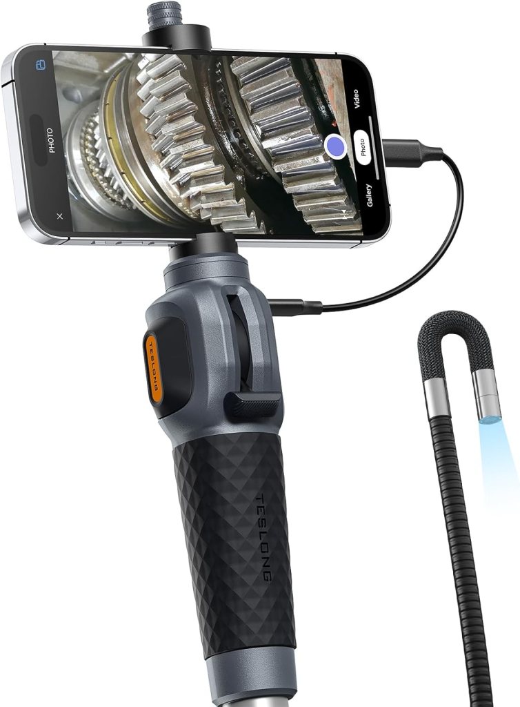 An endoscope connected to a smartphone, displaying a close-up view of mechanical gears.