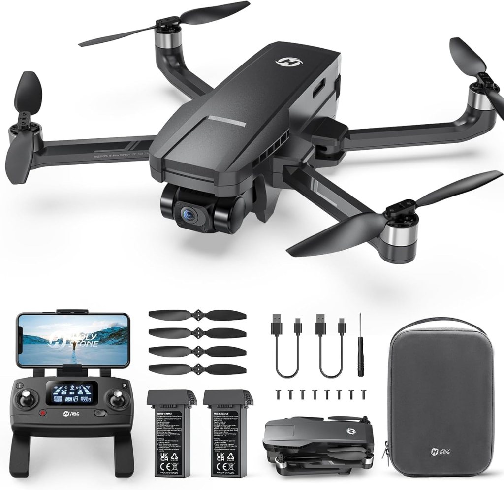 A black drone with four propellers and a front-facing camera, accompanied by a remote controller, spare propellers, two battery packs, charging cables, a screwdriver, and a carrying case.