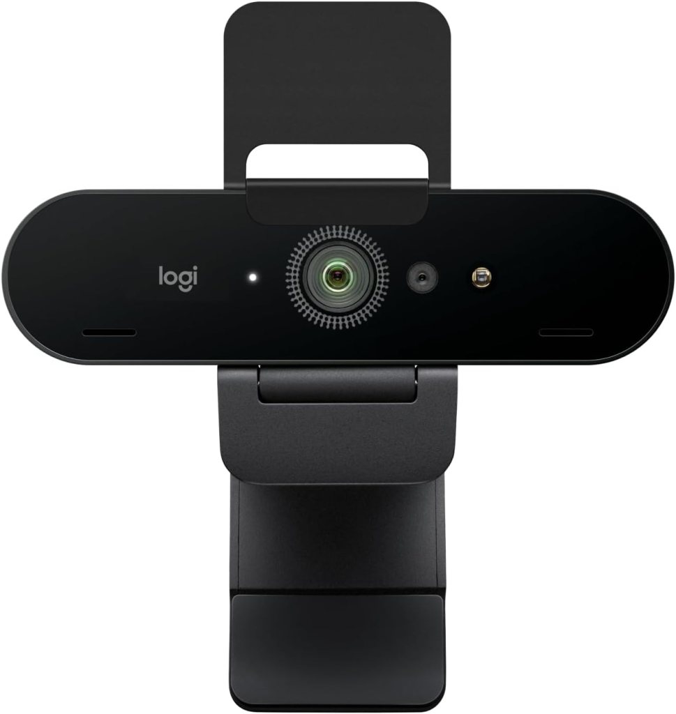 A black webcam with a central lens, an LED indicator, and a mounting clip for attachment to monitors.