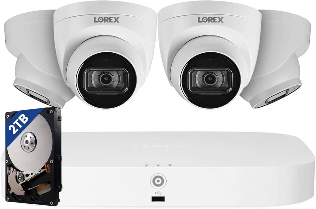 Two white Lorex security cameras and a 2TB hard drive, placed next to a white recording device.