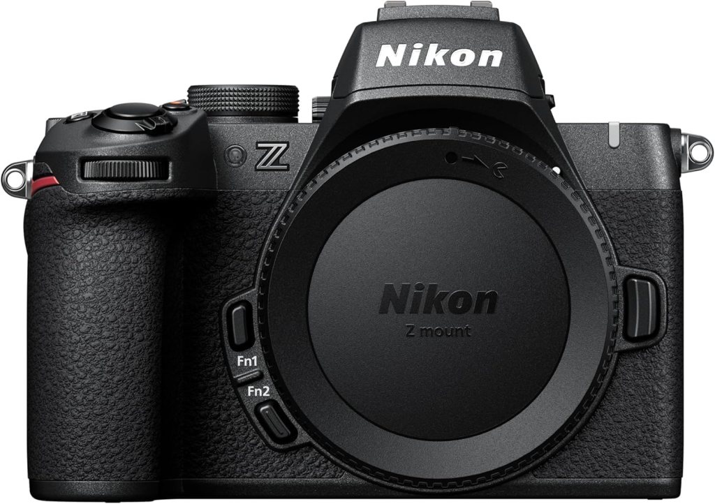 Front view of a Nikon Z-series camera featuring a textured grip and a lens cap with the Nikon logo.