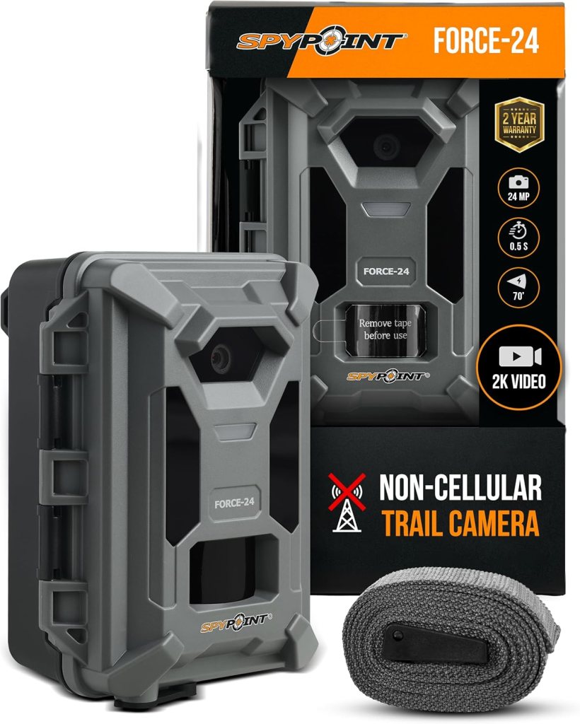 A Spypoint Force-24 non-cellular trail camera, featuring a 24 MP camera with 2K video capability, alongside a roll of mounting strap.